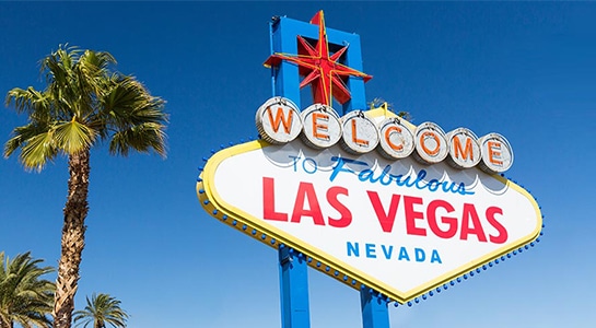 Las Vegas sign in Nevada in USA with palmtree and blue sky