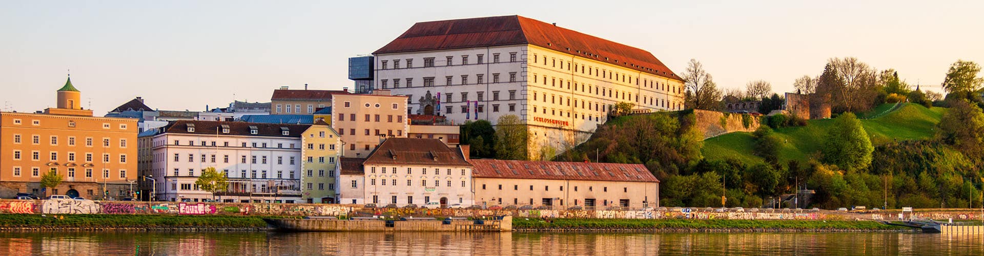 Linz castle at the riverside photographed on a sunny day.