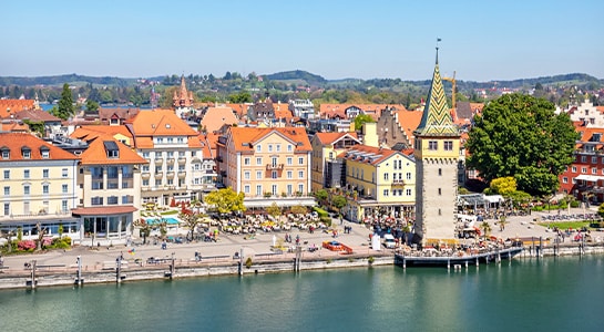 Mangturm tower in Lindau, Germany, located at the front of the lake with the city in the background.