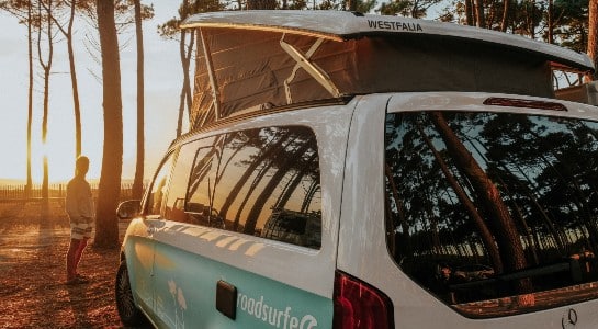 Mercedes Benz Vito camper in a forest looking into the sunset