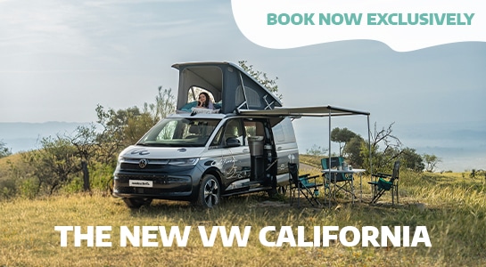 New VW California Campervan In A Field With The Pop Up Roof And Camping Table Set Up