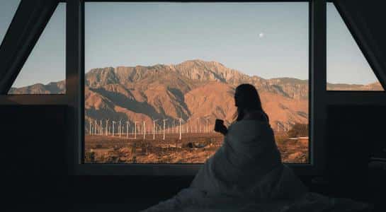 Morning coffee with mountain views and wind turbines outside Palm Springs, the kind of reset people take on a weekend away from LA