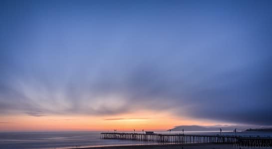 Pismo Beach Pier glowing at sunset on California’s Central Coast, part of the best surfing in California