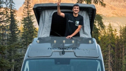 Pop up camper van with roof sleeping area in the mountains