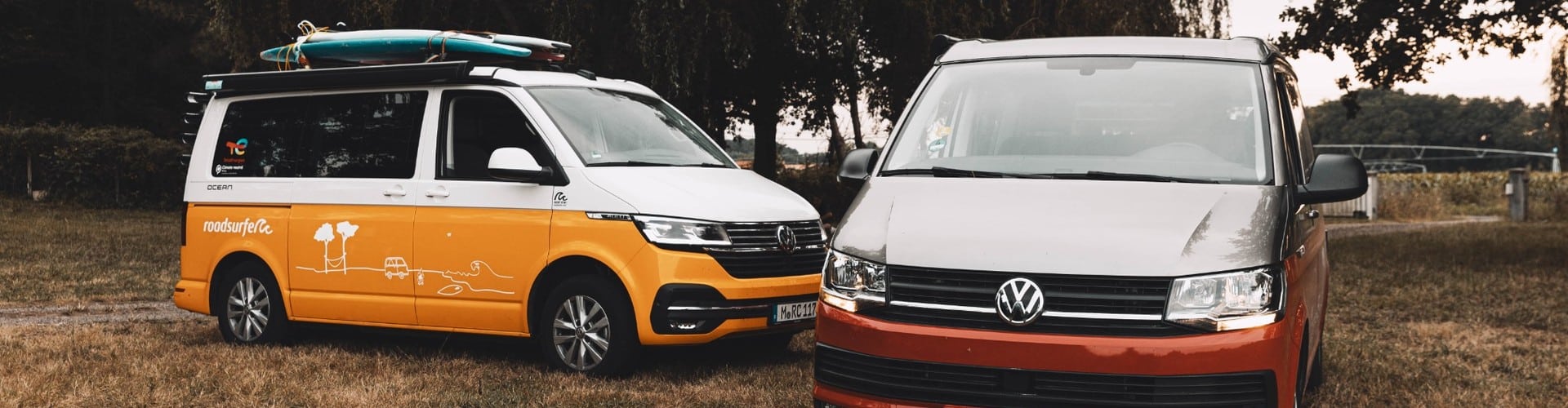 Two camper vans parked outdoors, showing different options for renting a camper and planning a road trip