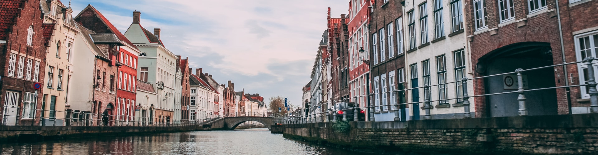 View of river that flows between historic buildings in Belgium