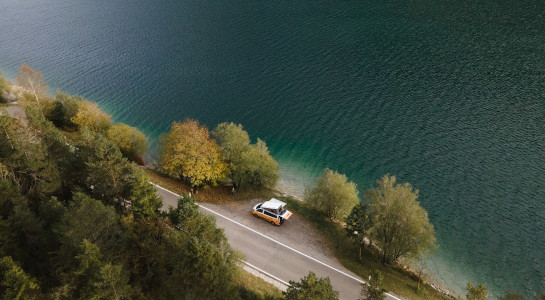 Drone shot of a roadsurfer camper at a lake