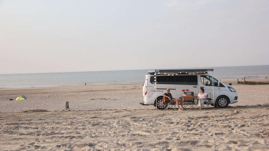 white van standing on the beach