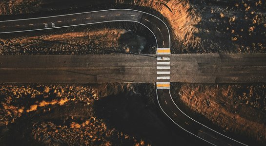 Aerial view of a rural highway intersection representing historic Route 66 alignment and modern connectors