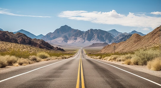 Route 66 leading towards the mountains in the background.