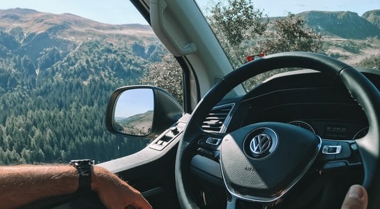 Driver’s view looking out of an RV toward mountain scenery for an RV classes guide