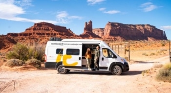 Camper van parked in the Utah desert landscape, showing typical RV rental prices for road trips in the U.S.