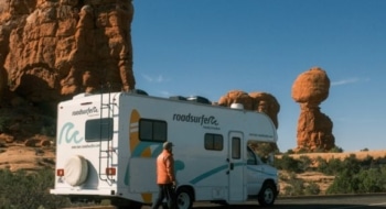 Mid-size RV parked near rock formations in Arches, illustrating the best RV size for national parks with narrow roads