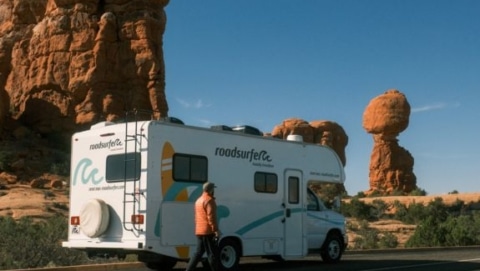 Mid-size RV parked near rock formations in Arches, illustrating the best RV size for national parks with narrow roads