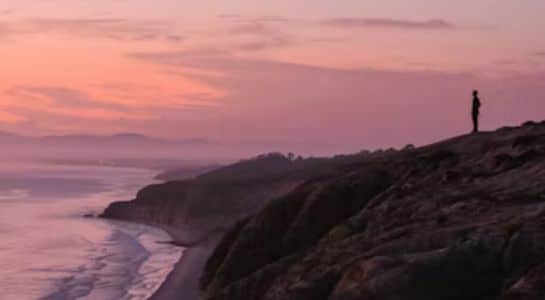 Ocean cliffs and calm water at Sunset Cliffs Natural Park in San Diego at dusk