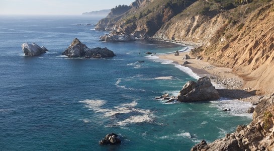 Sand Dollar Beach framed by Big Sur’s rugged cliffs and turquoise coastline, one of the best surfing beaches in California