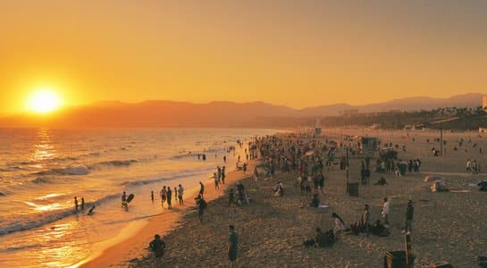 Crowds enjoying sunset at Santa Monica Beach along the California coast during an RV road trip