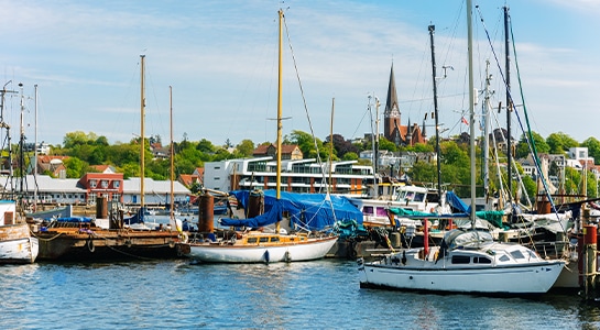 Tiny fishing boats docked at a port in Flensburg.