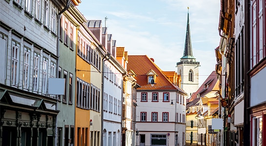 street view with church tower at the old town of erfurt city in germany