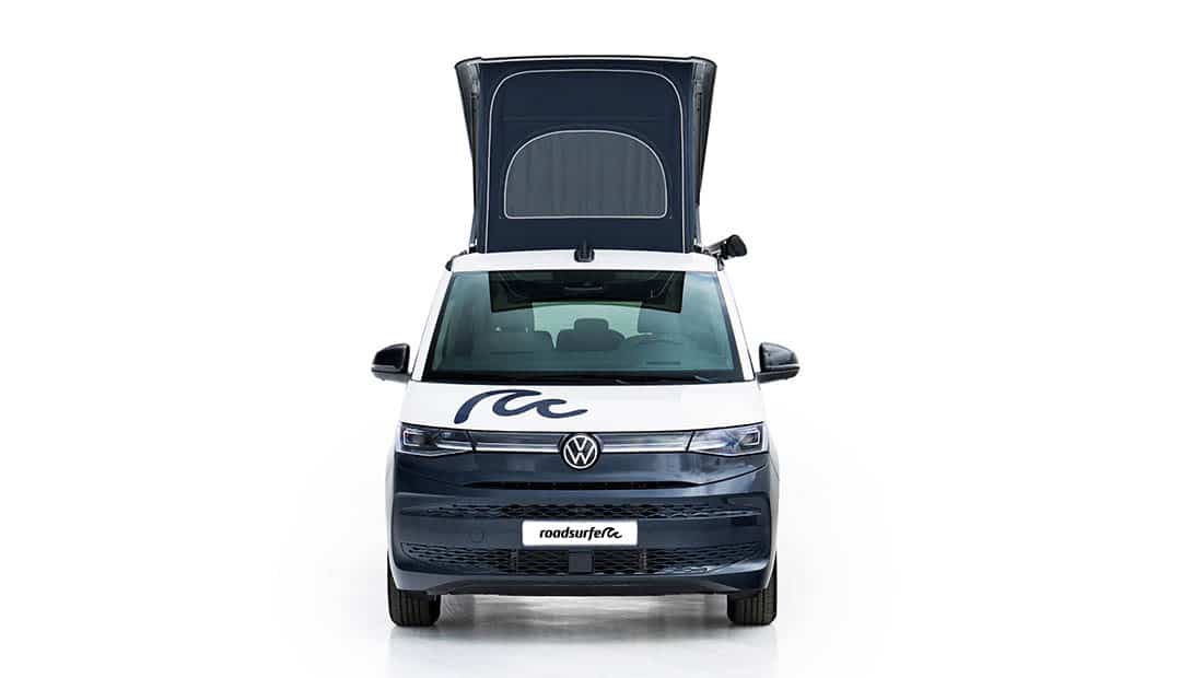 new vw california ocean as roadsurfer campervan sunrise suite in dark blue from the front with pop up roof open