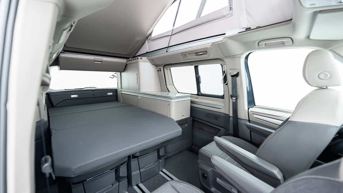 roadsurfer Sunrise Suite interior view showing the bed from the front