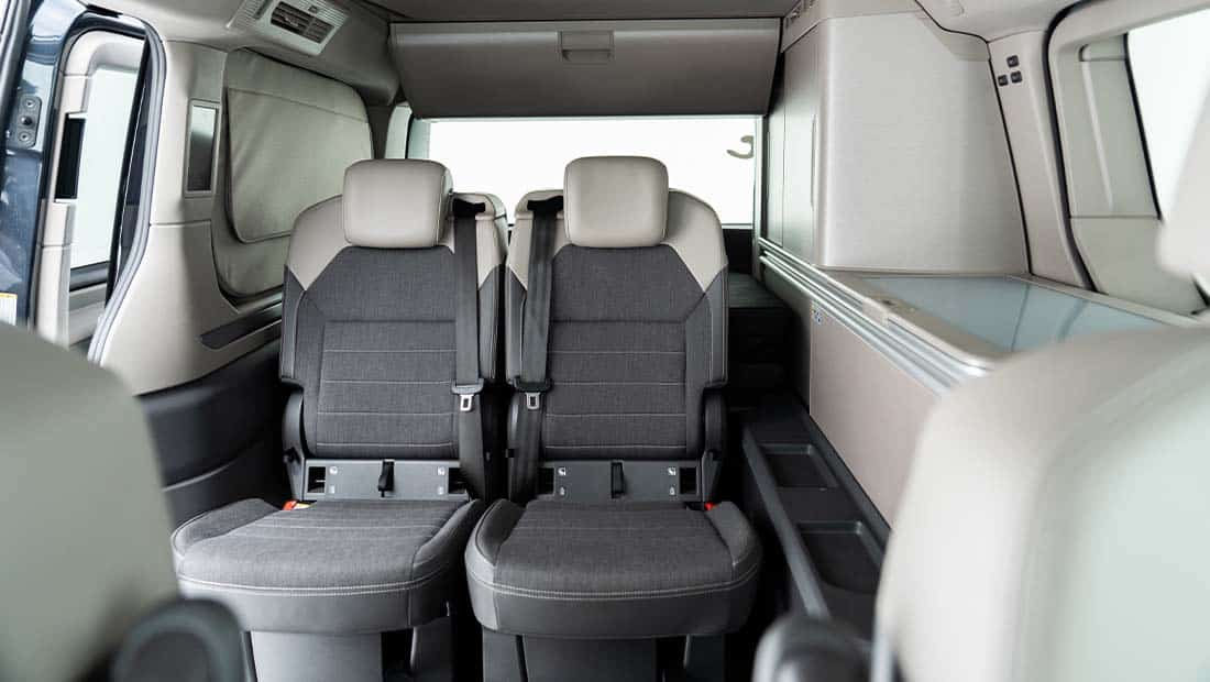 roadsurfer Sunrise Suite interior view showing the rear seating area