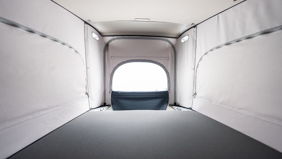 roadsurfer Sunrise Suite interior view showing the roof tent to the front