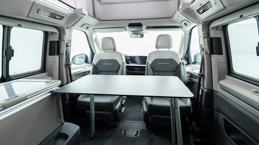 roadsurfer Sunrise Suite interior view showing the seating area with the