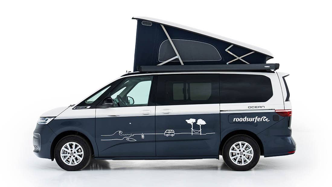 new vw california ocean as roadsurfer campervan sunrise suite in dark blue with pop up roof from the sideview