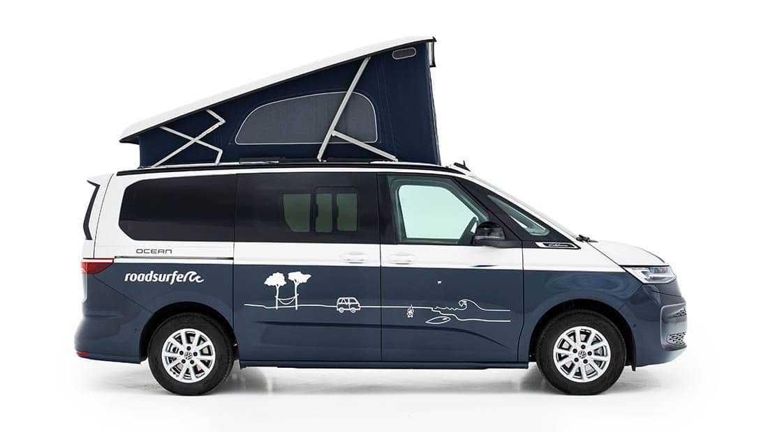 new vw california ocean as roadsurfer campervan sunrise suite in dark blue with pop up roof from the sideview