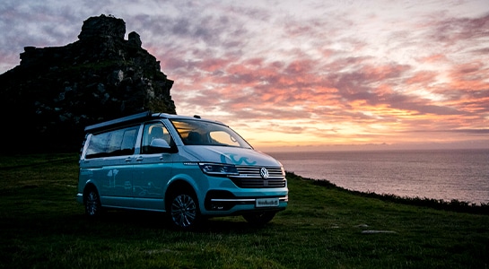 sunset near the sea with the camper