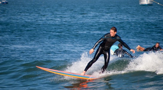 Longboard surfer riding a mellow wave at Surfrider Beach in Malibu