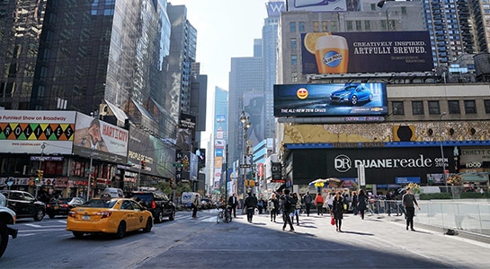 Times Square in New York with it's skyscapers and ad screens.