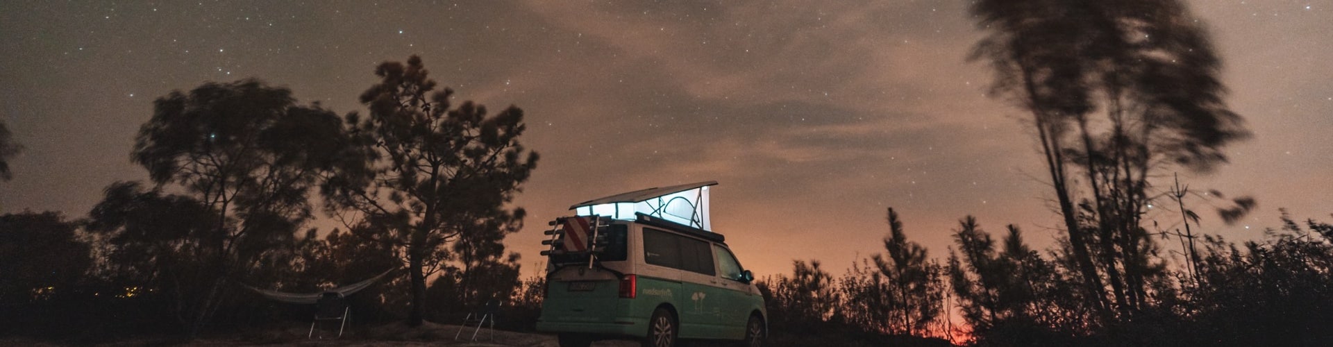 Camper van beneath a vast starry sky near Los Angeles, capturing the calm and beauty of night camping in Southern California.