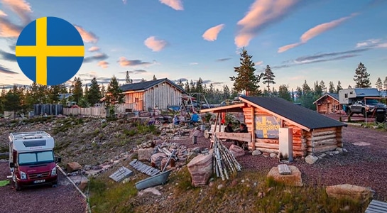 Typical Swedish huts on a mountain, forest in the background, at sunset