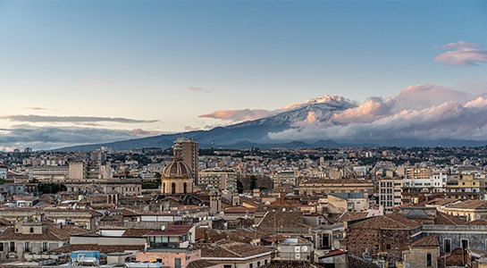 City view over Catania with the volcano in the back that is hidden behind clouds.