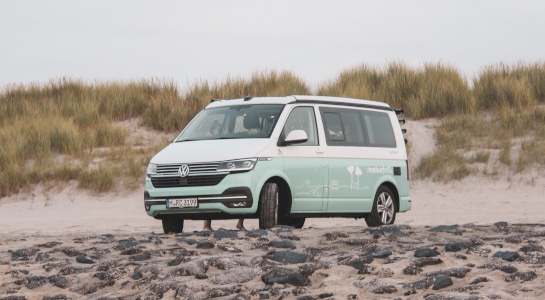 vw campevan parked on the beach in the Netherlands