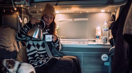 Woman making coffee inside an RV during a long term RV rental stay