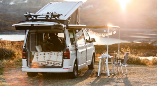 white campervan near the water at sunrise