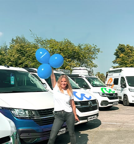 Woman stands with balloons in hands