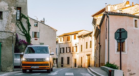 yellow campervan in a small town